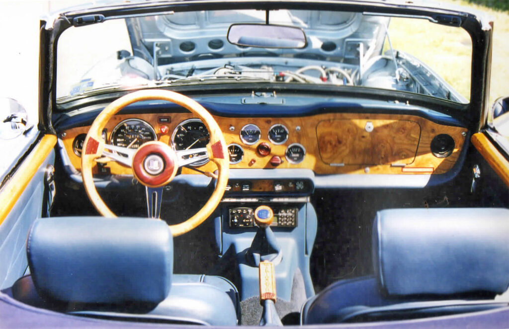 A car with the dashboard and steering wheel in front of it.