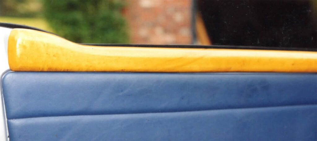 A close up of the handle on a blue and yellow car.