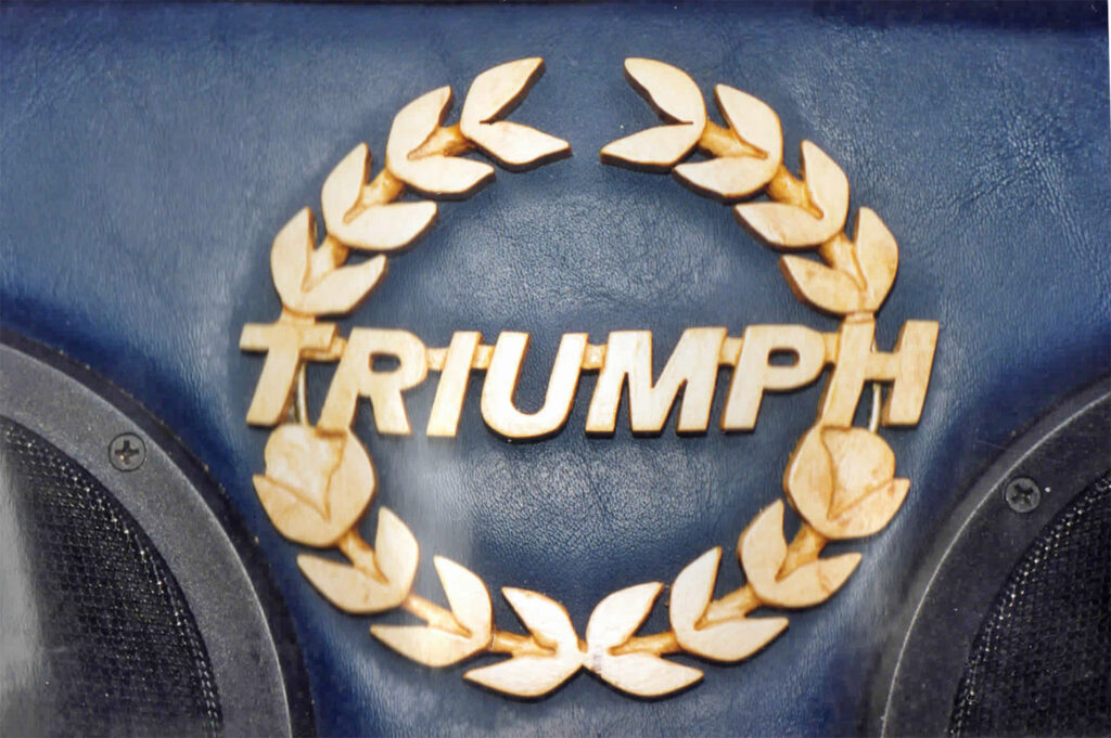 A close up of the triumph logo on a motorcycle
