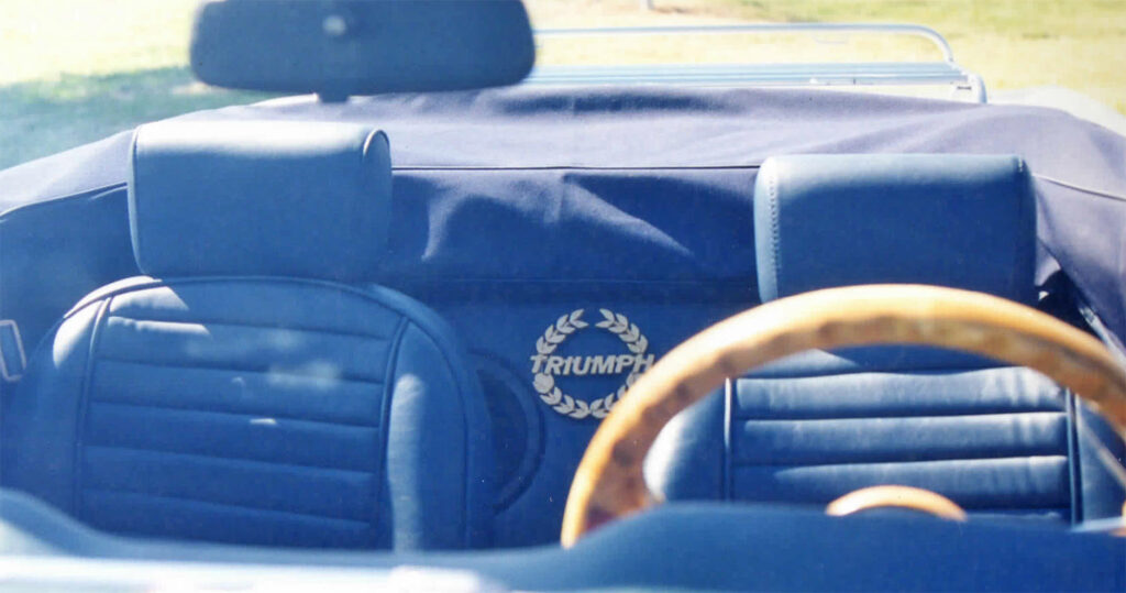 A blue car with the name triumph on it.