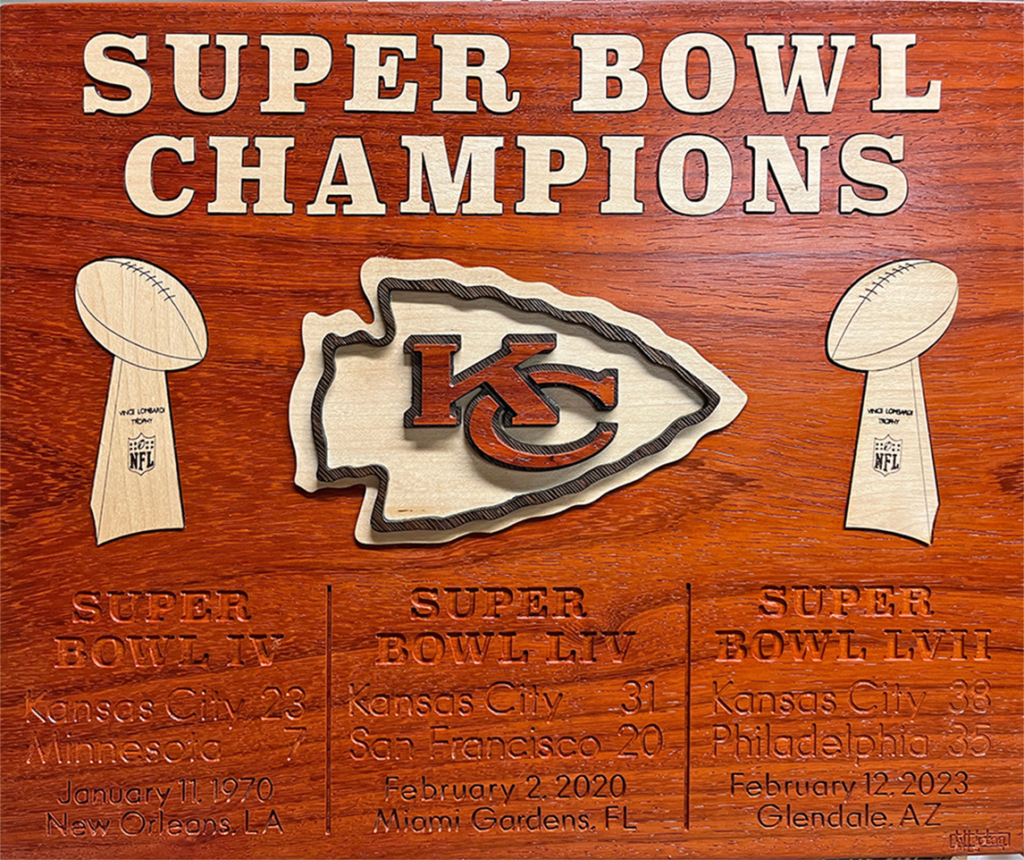 A wooden sign with the kansas city chiefs logo and their super bowl trophies.