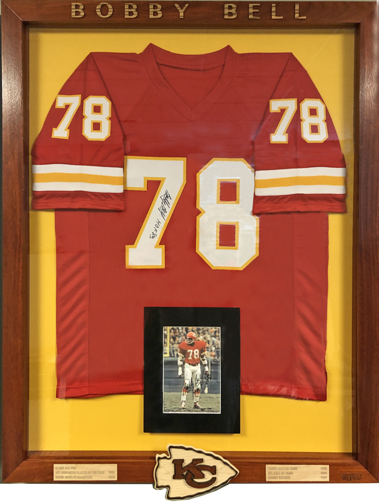 A framed jersey and photo of an nfl player.