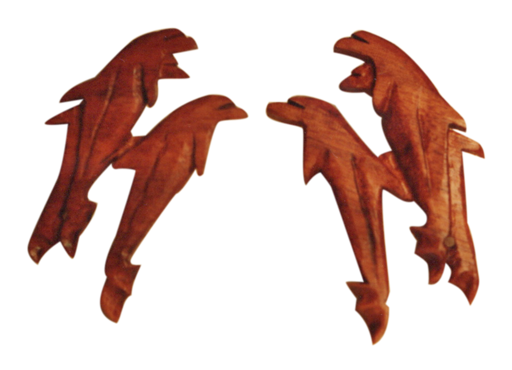 A group of four orange dolphins that are flying.