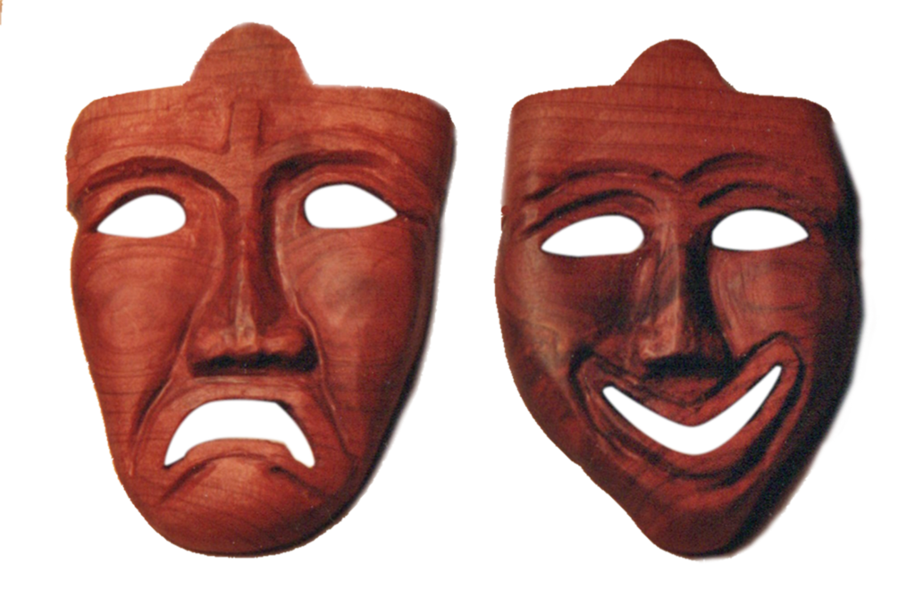 Two wooden masks of different faces are shown.