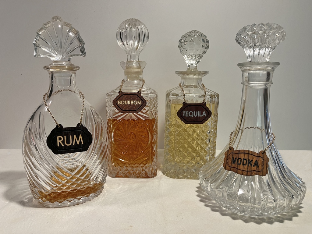 A group of four different bottles with labels on them.