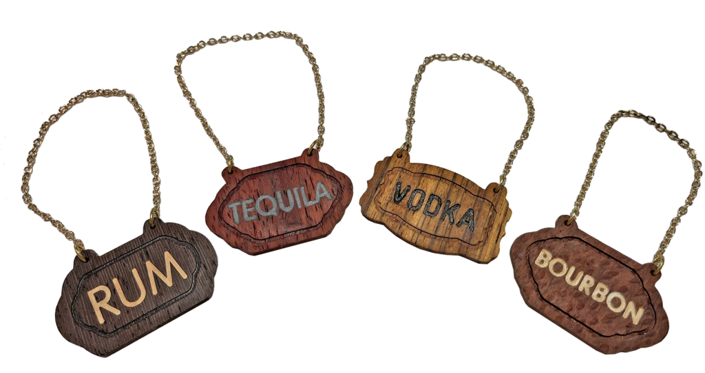 A group of four wooden signs that say " tequila vodka."