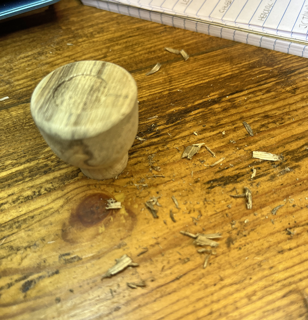 A wooden table with some wood chips on it