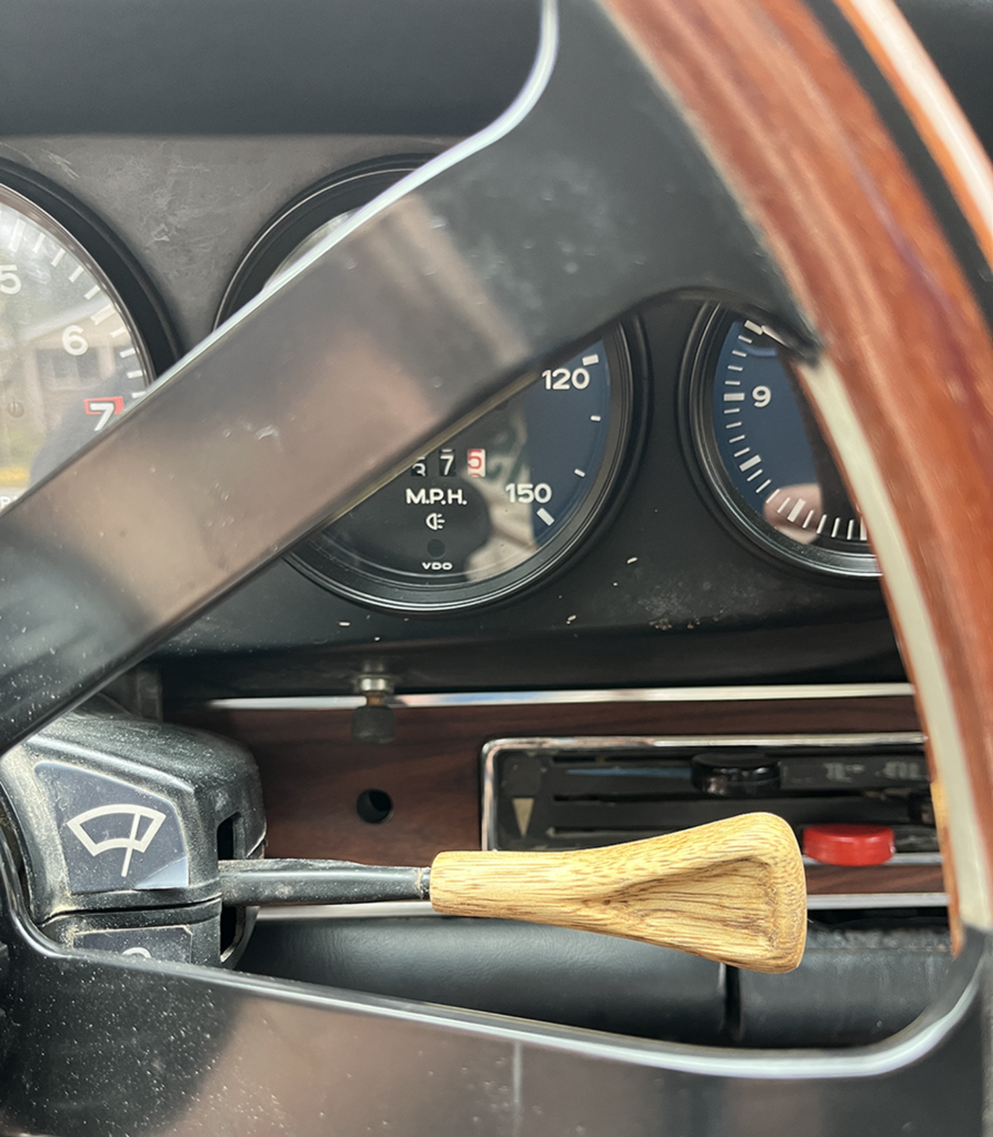 A close up of the steering wheel and gauges